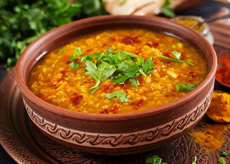 indian-dhal-spicy-curry-bowl-spices-herbs-rustic-black-wooden-table_2829-18712
